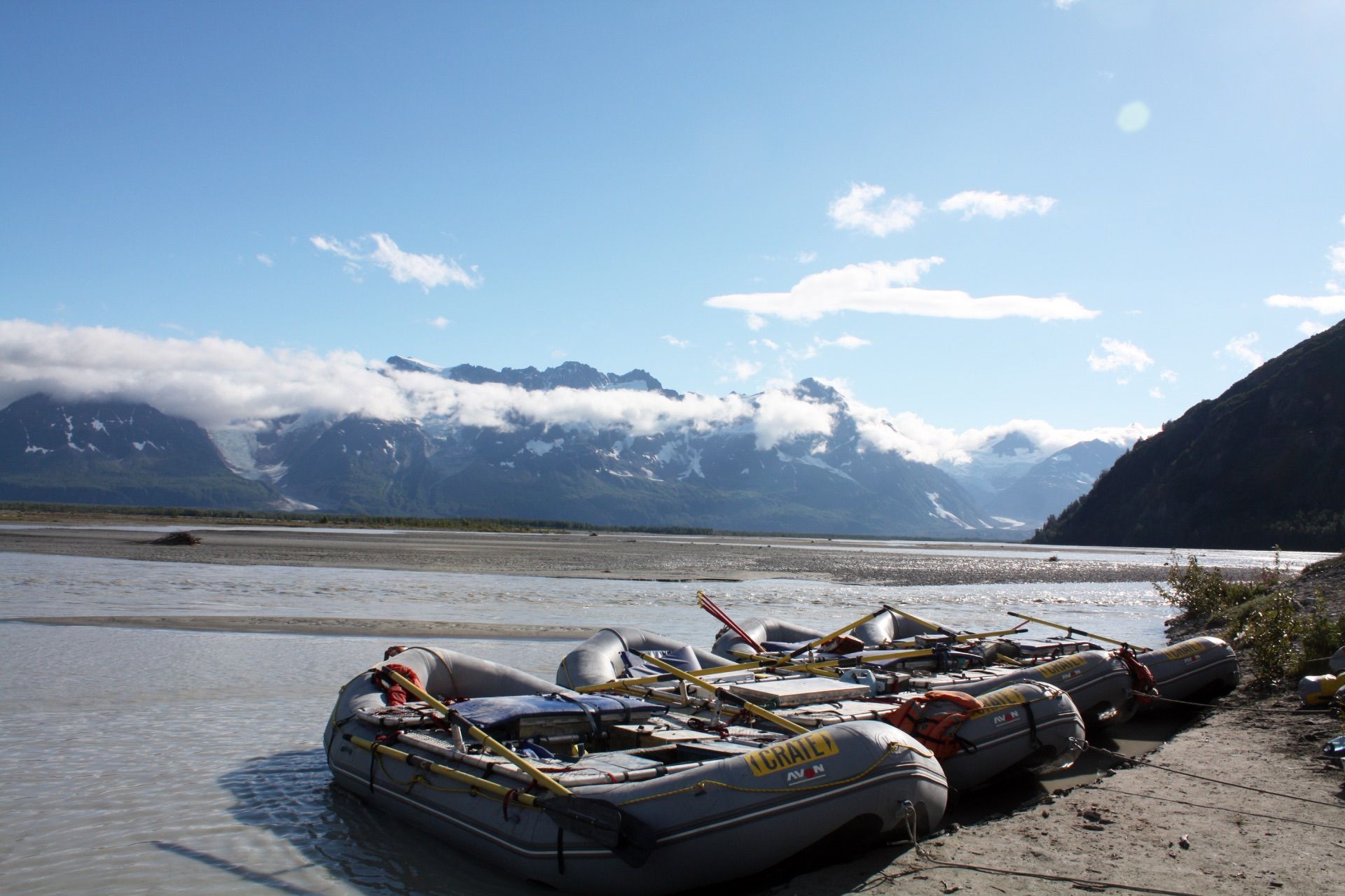 Avon rafts camped at the confluence of the Tatshenshini and Alsek Rivers on a sunny warm day.