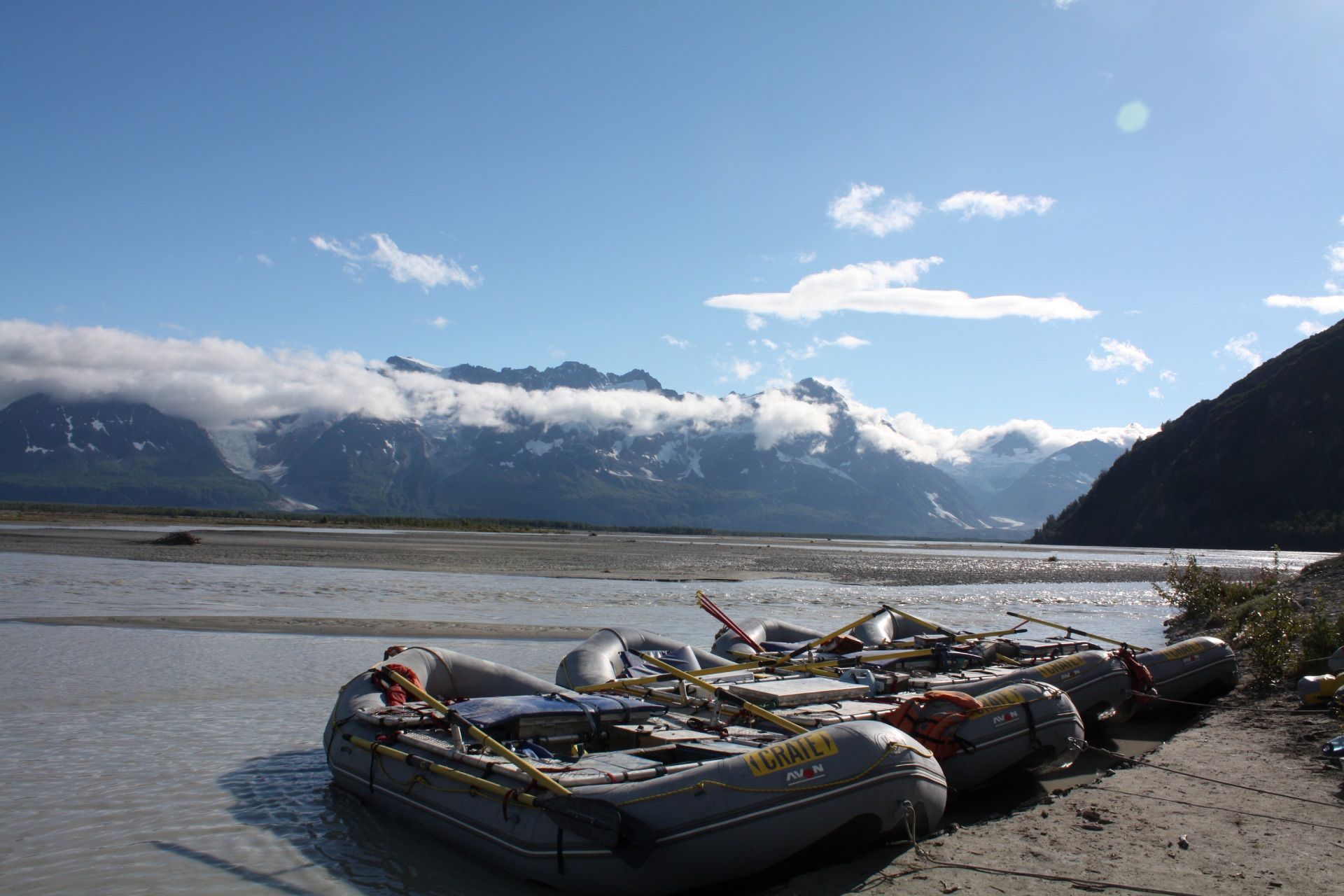 Cataract Canyon River with boats in front of a large rock formation