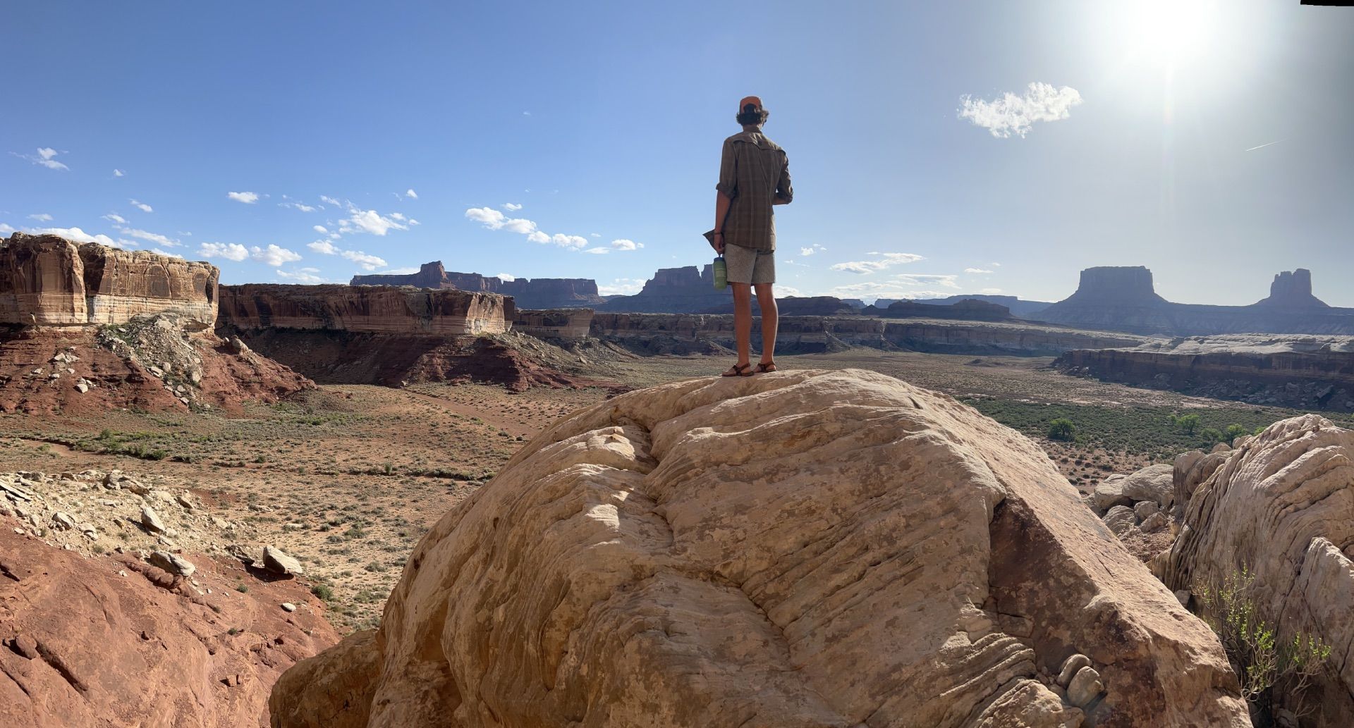 Cataract Canyon River with boats in front of a large rock formation