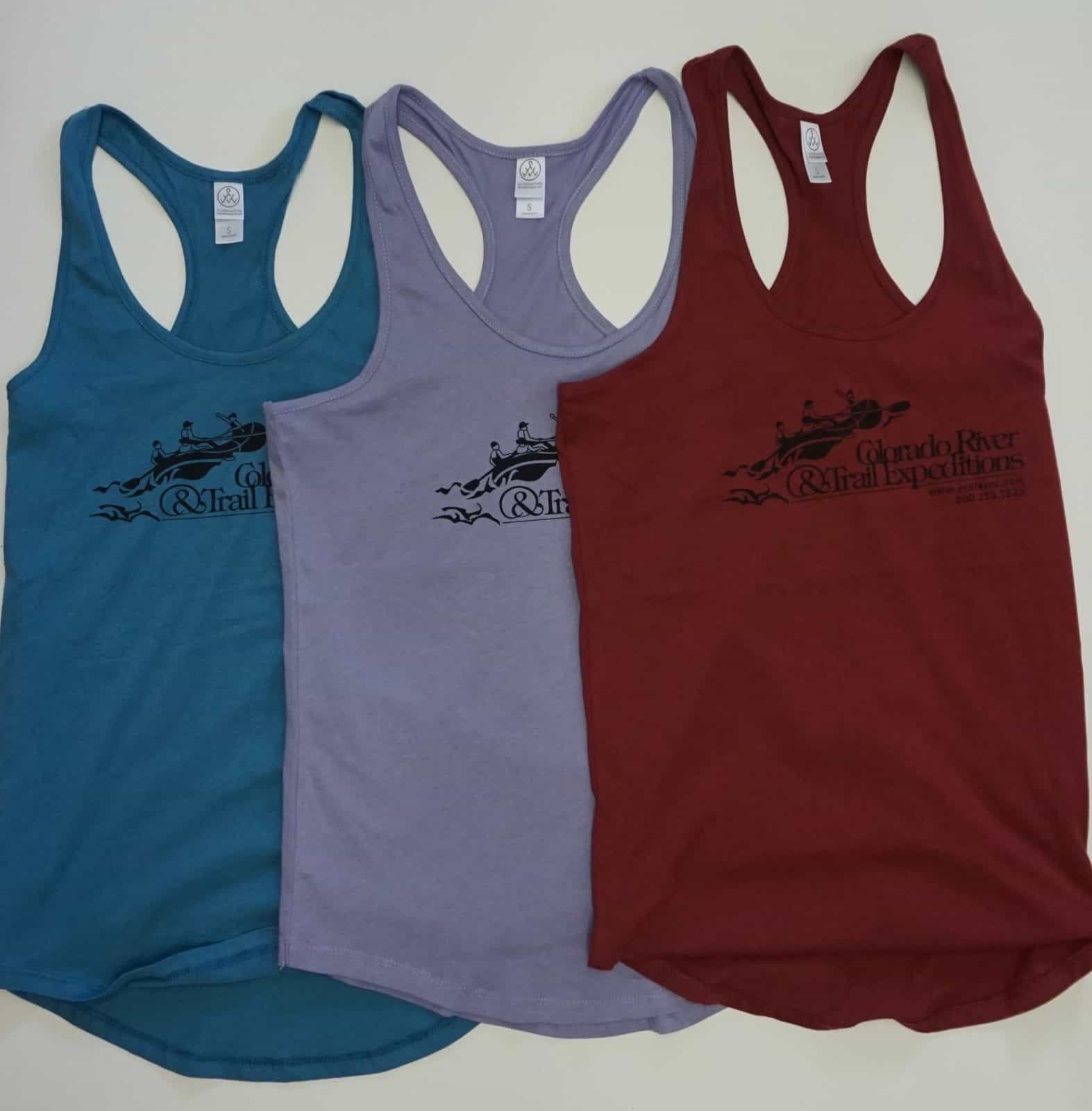 Three tank tops: teal, purple, and maroon, with a black graphic on each.