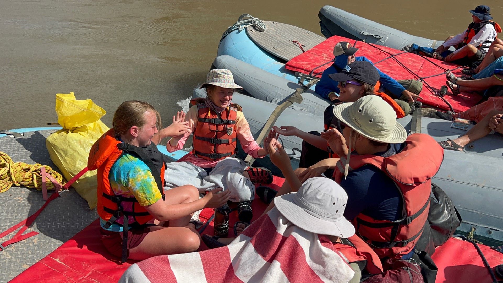 Cataract Canyon River with boats in front of a large rock formation