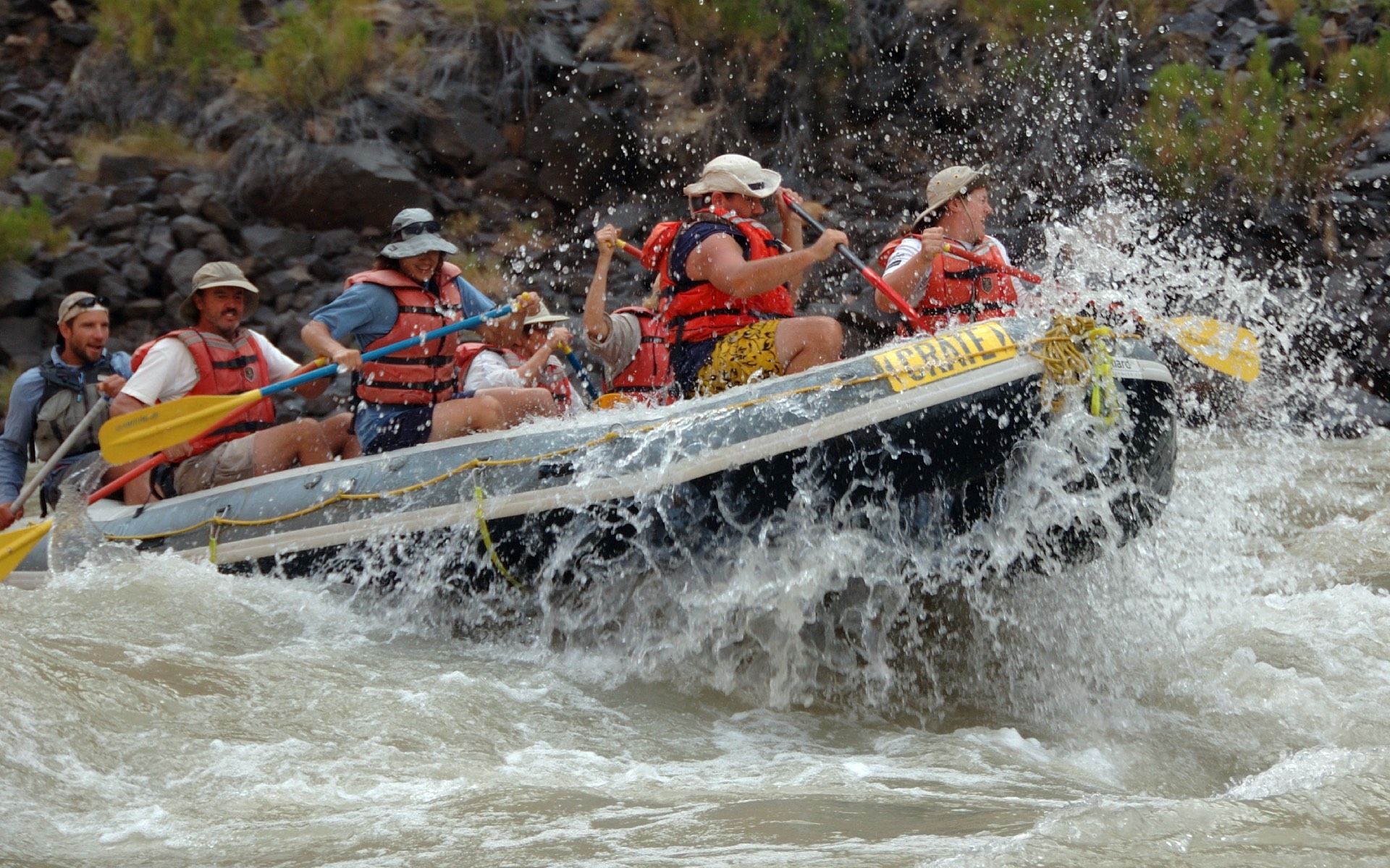Rafting on a river. People in a raft, water splashing.
