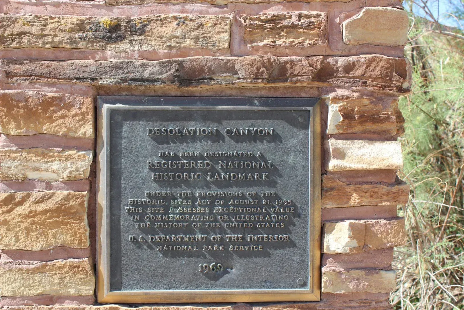 Bronze plaque on a sandstone wall: