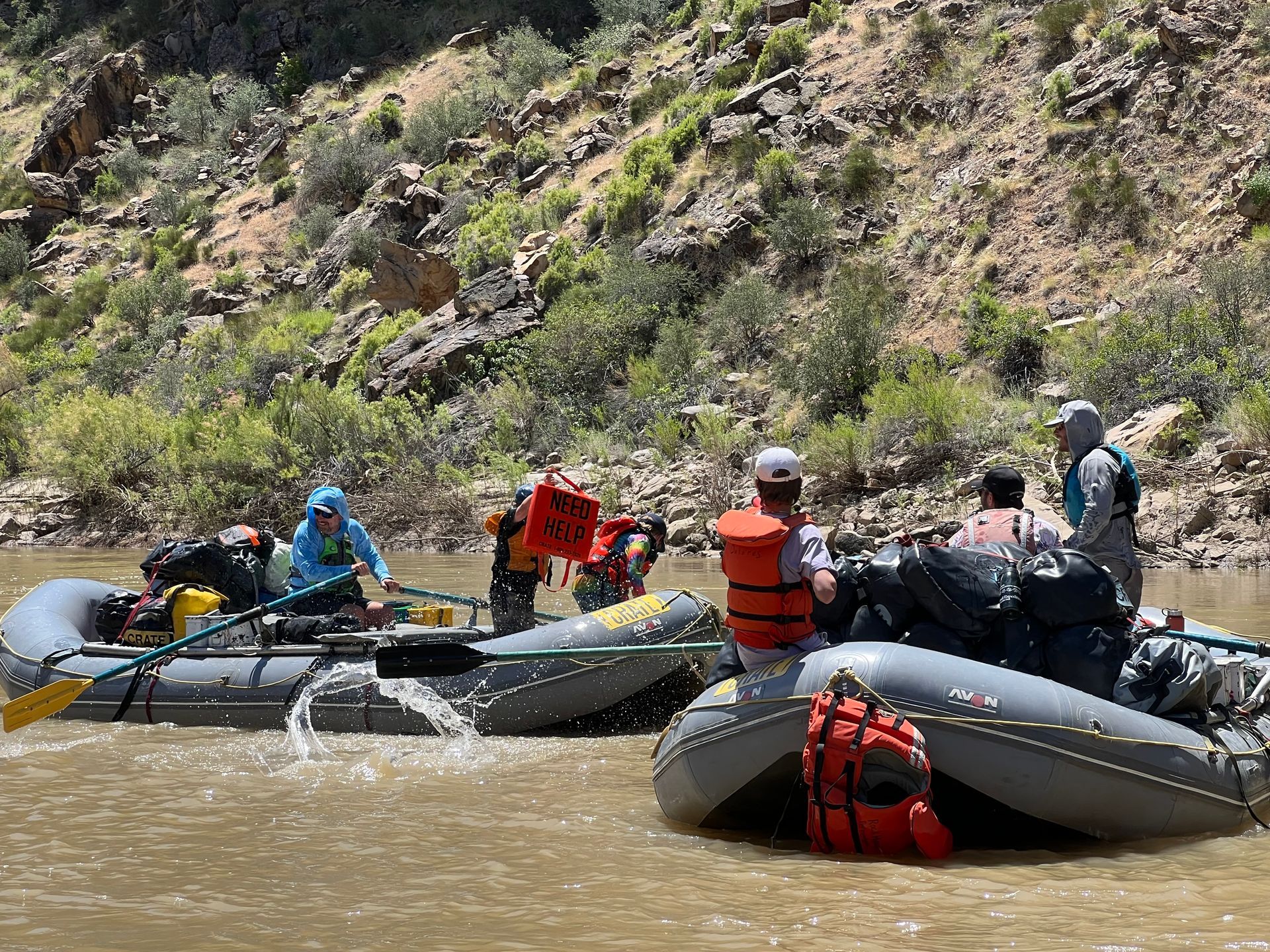 Two rafts having a great time water fight ing on the Green River in Desolation Canyon.