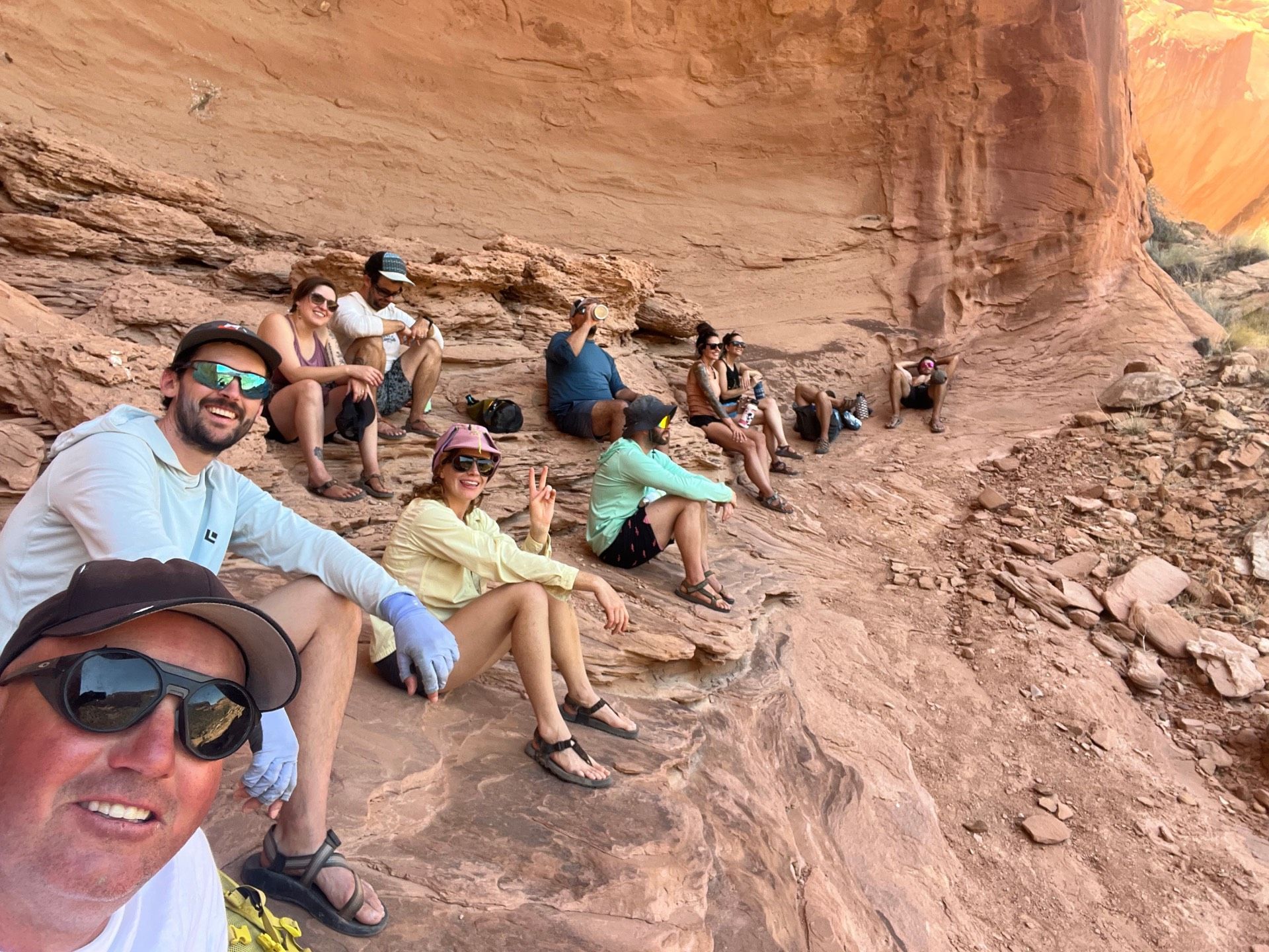 Group of people resting in a sandstone alcove