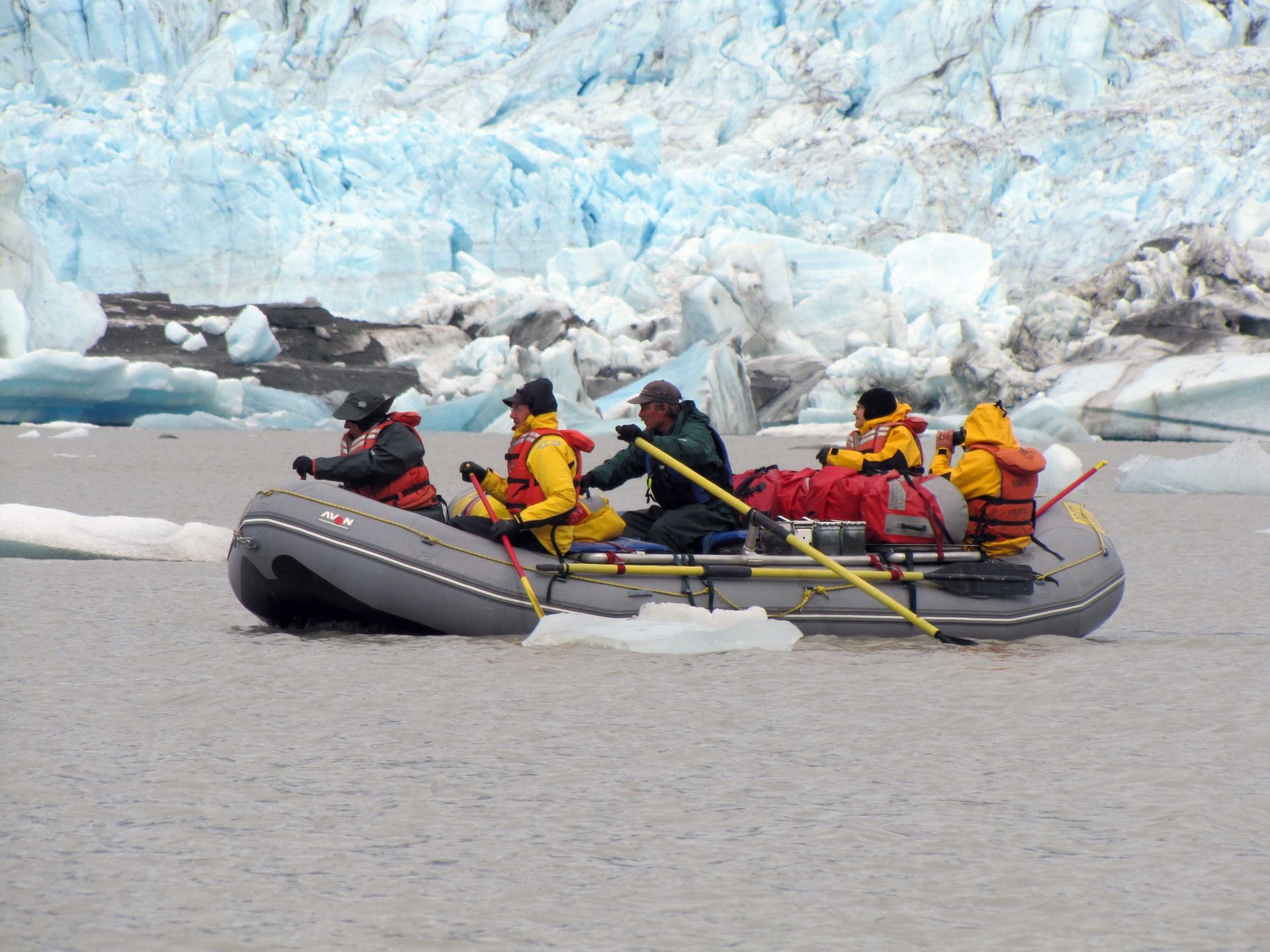 Cataract Canyon River with boats in front of a large rock formation