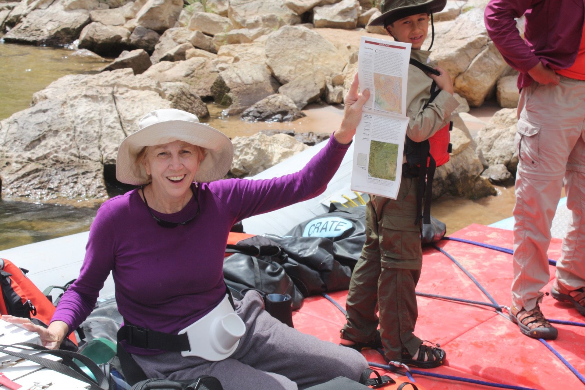 Cataract Canyon River with boats in front of a large rock formation