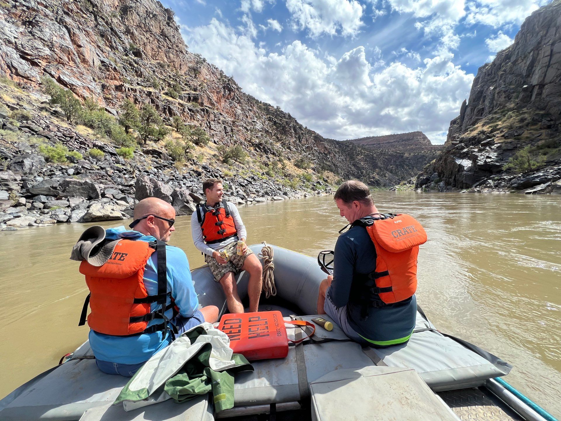 Cataract Canyon River with boats in front of a large rock formation