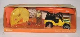 Toy camping set with yellow jeep, orange canoe, yellow tent, and a figure, in a box.