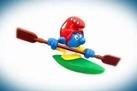 Smurf in red-and-white hat, paddling green kayak, yellow shirt.