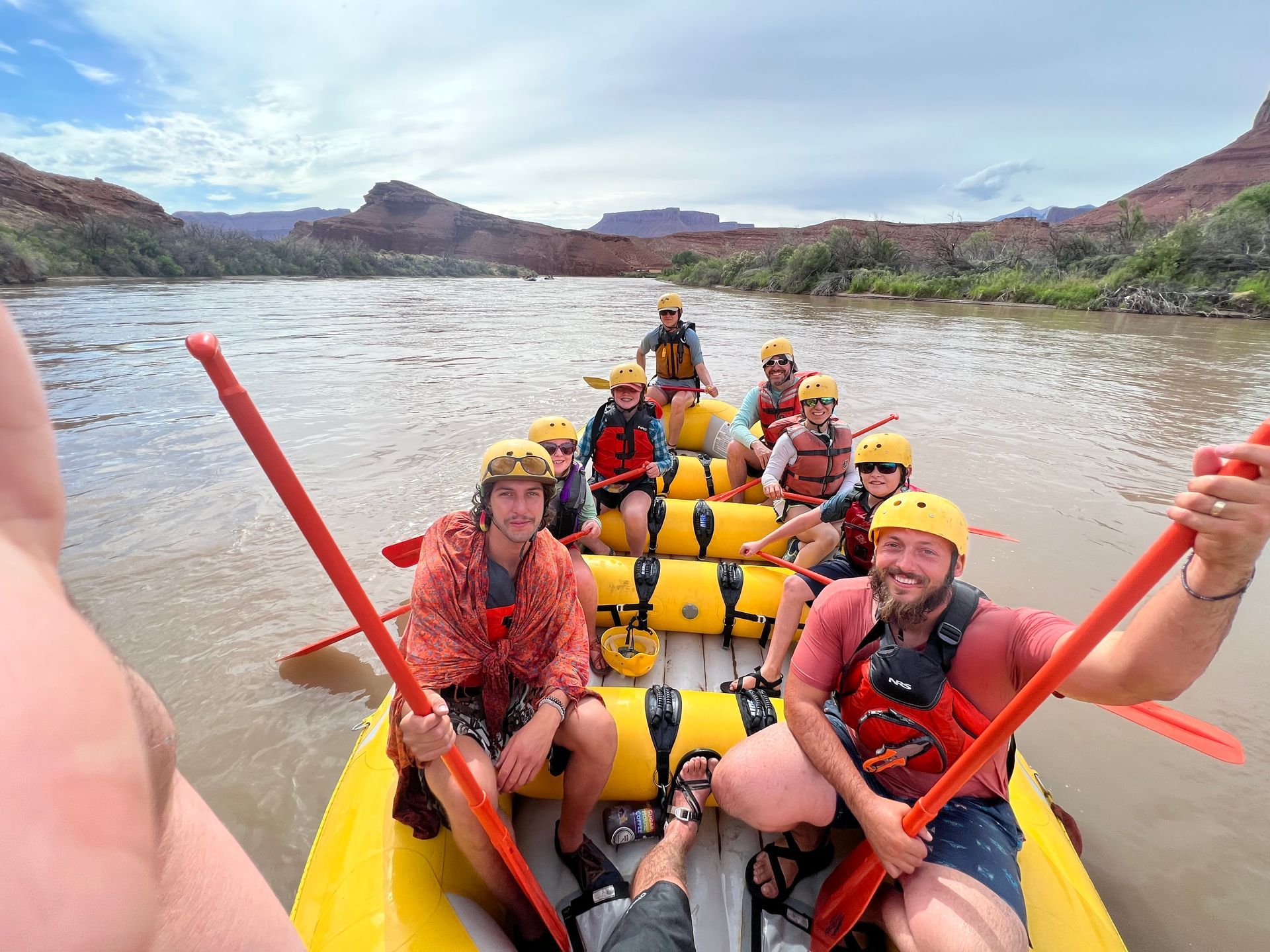 Family taking a photo at the top of the  Desolation Canyon with Green River View at the bottom