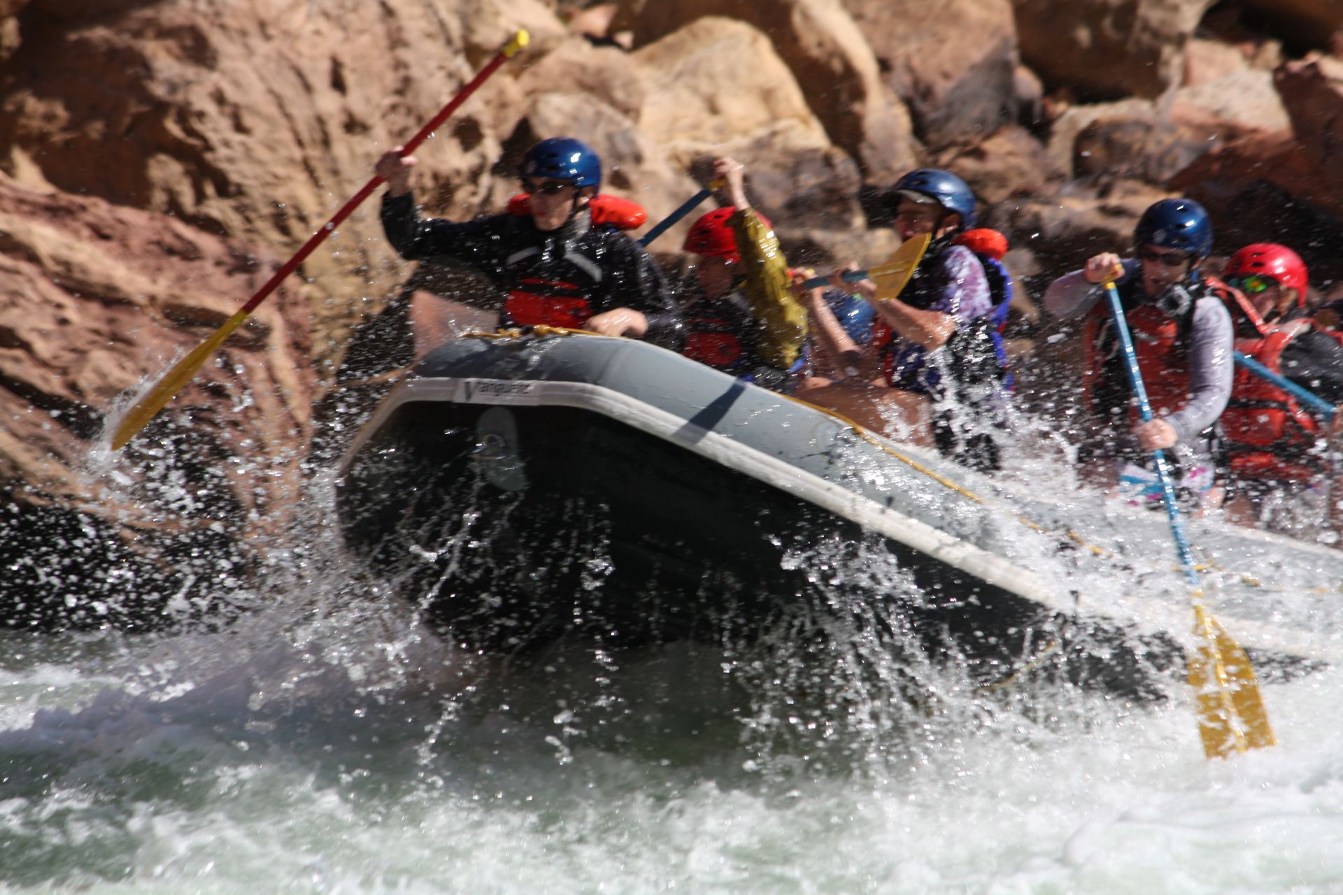 Whitewater rafters paddling through rapids.