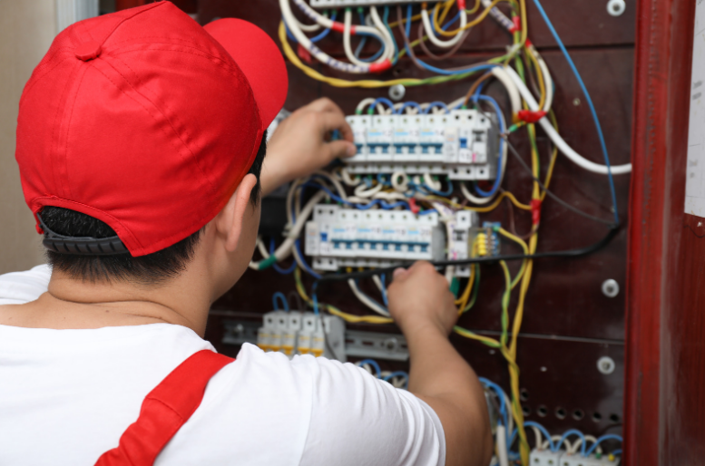 A man is holding a bunch of wires in his hands.