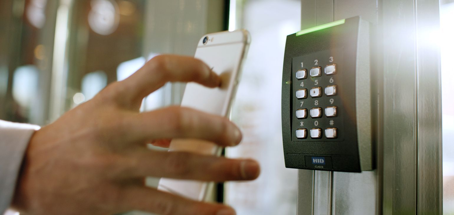 A person is using a cell phone to unlock a door.
