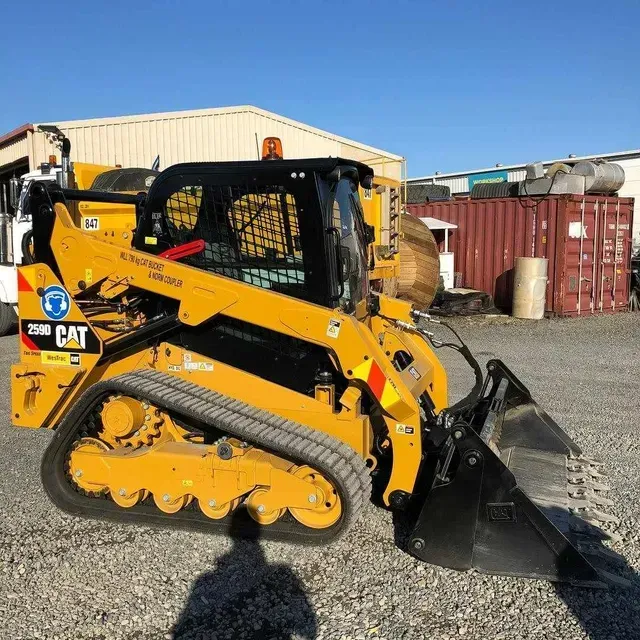 Yellow Caterpillar skid steer loader with tracks, outside on a sunny day — B & D Bunt Earthmoving Contractors in North Boambee Valley, NSW