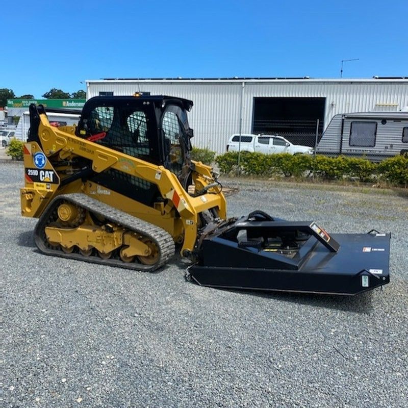 Yellow Skid Steer With a Black Brush Cutter on a Gravel Lot — B & D Bunt Earthmoving Contractors in North Boambee Valley, NSW