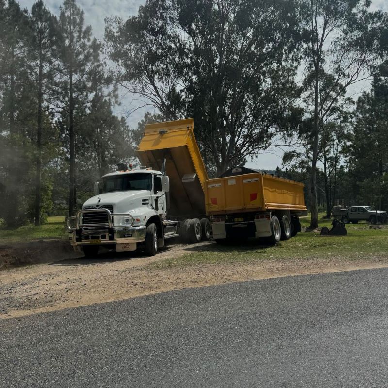A White Tipper Truck With a Yellow Trailer — B & D Bunt Earthmoving Contractors in North Boambee Valley, NSW