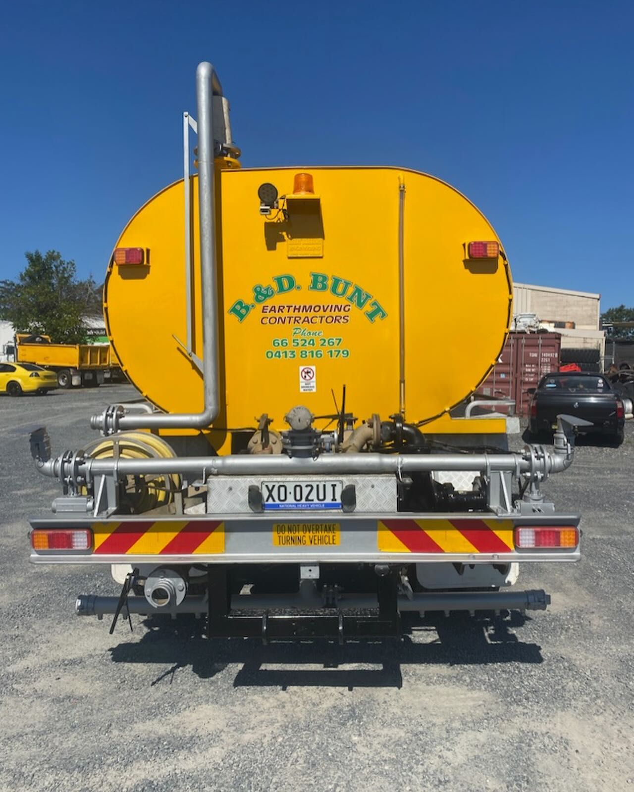 Yellow B & D Bunt Truck Rear View — B & D Bunt Earthmoving Contractors in North Boambee Valley, NSW