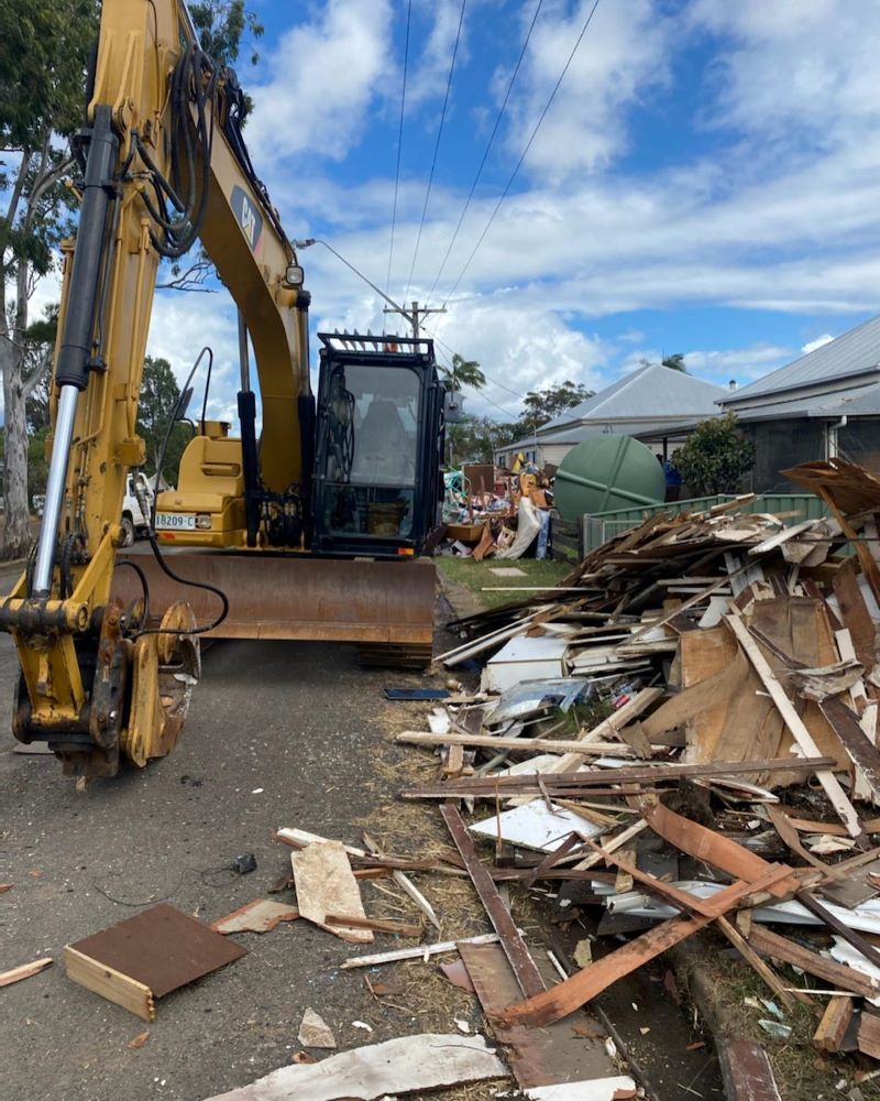 Excavator Clearing Debris From a Demolition Site — B & D Bunt Earthmoving Contractors in North Boambee Valley, NSW