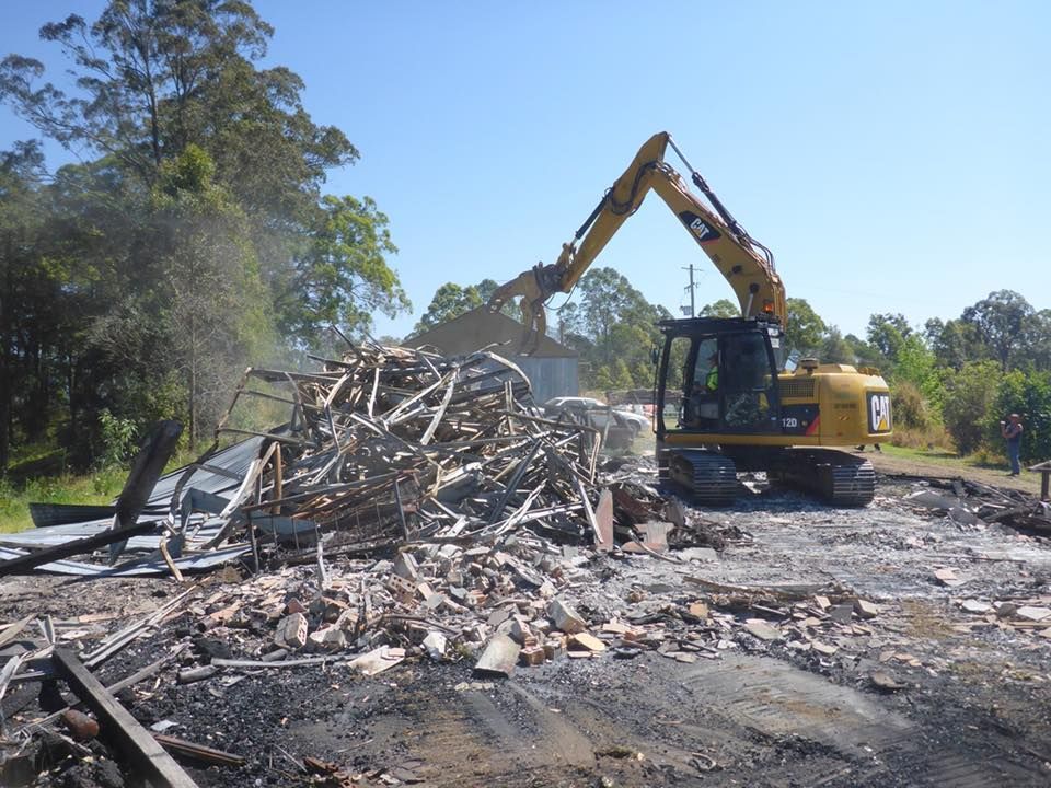 A Yellow Excavator Demolishing — B & D Bunt Earthmoving Contractors in North Boambee Valley, NSW