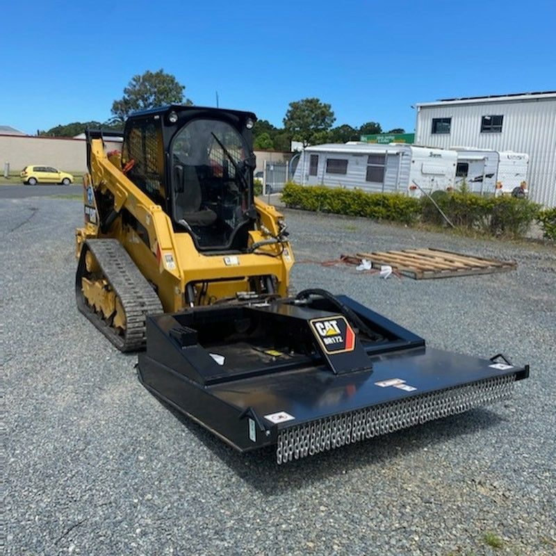 Yellow Caterpillar Skid Steer With Brush Cutter Attachment — B & D Bunt Earthmoving Contractors in North Boambee Valley, NSW