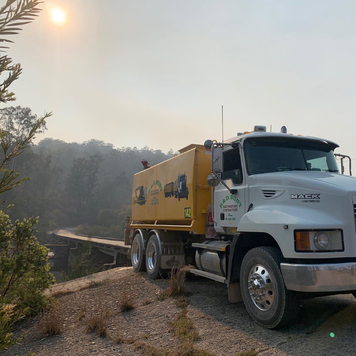 A Water Truck on a Dirt Road — B & D Bunt Earthmoving Contractors in Grafton, NSW