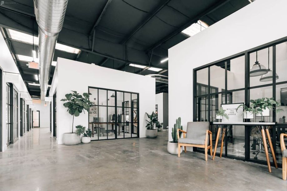 A large room with a lot of windows and chairs in it.