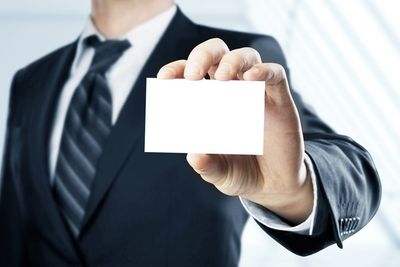 Man Handing a Blank Business Card