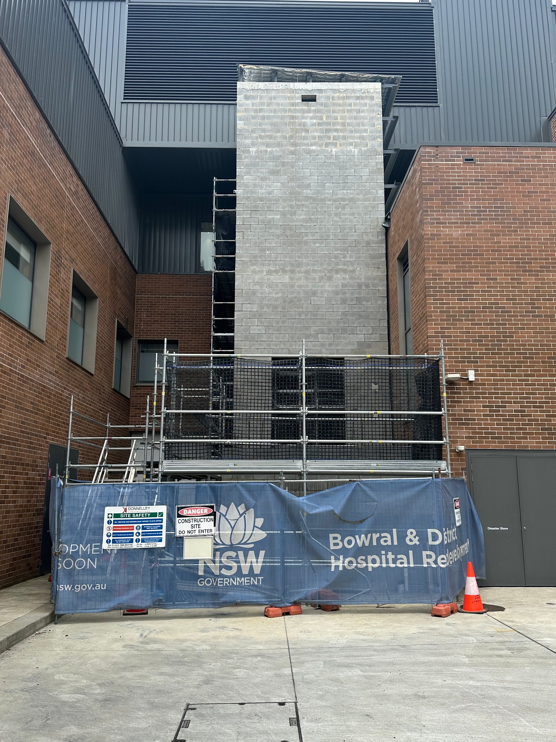 A large brick building with a blue banner in front of it.