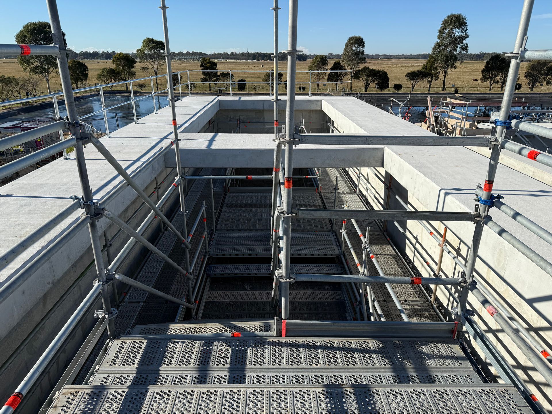 A man standing next to a set of stairs with a sign that says liverpool on it.