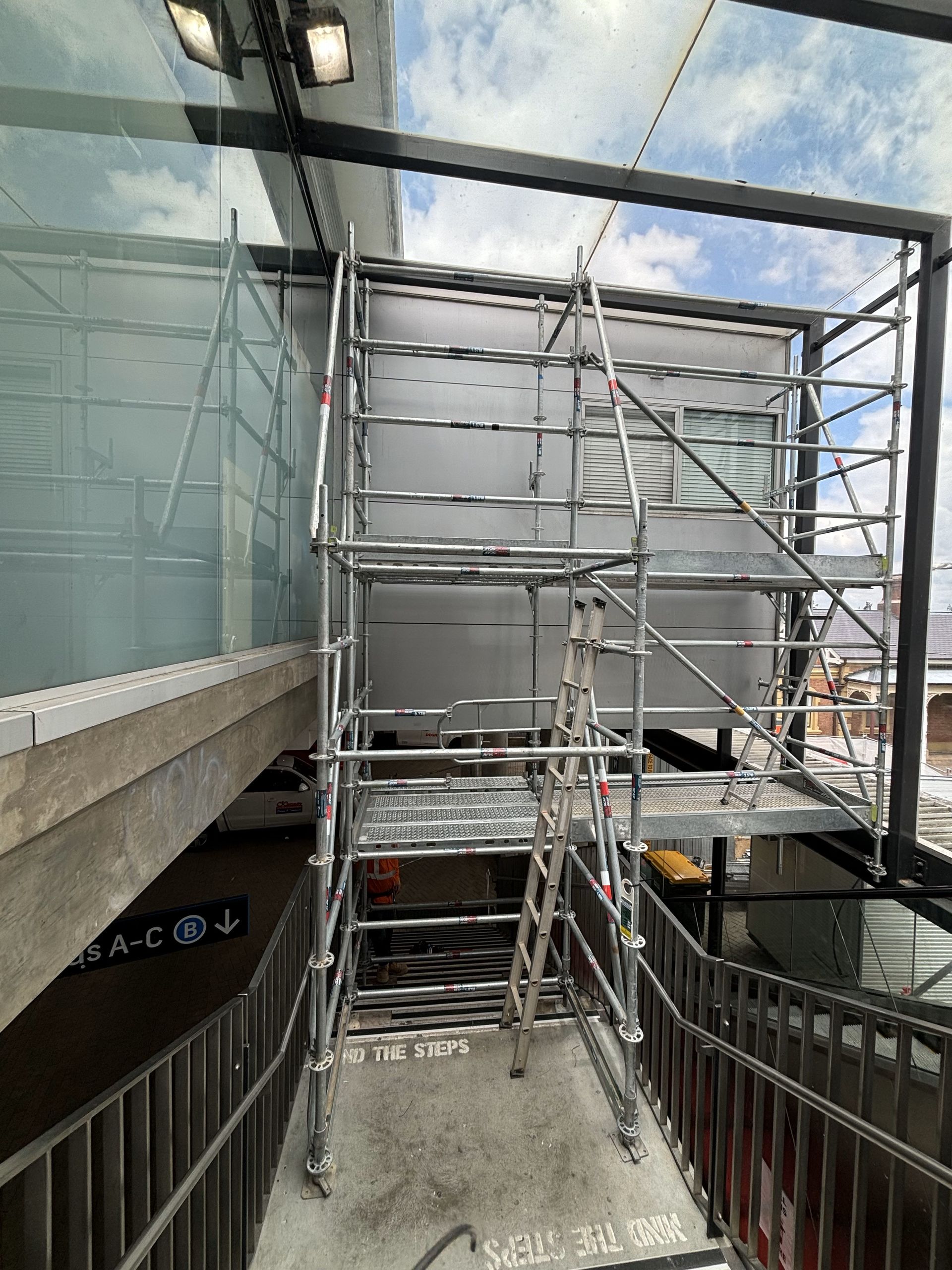 A metal scaffolding is being used to build stairs in a building.