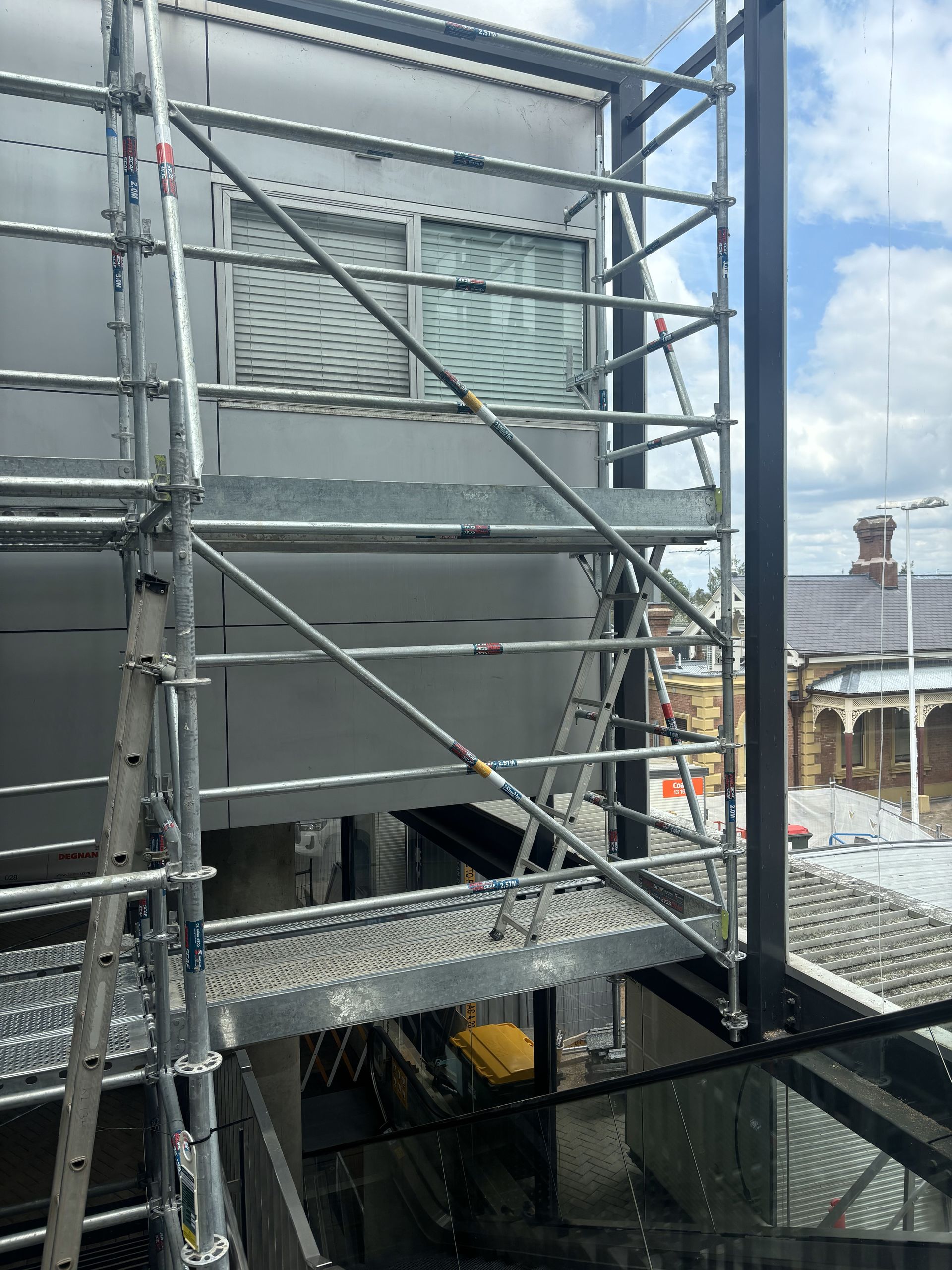 Scaffolding is being built on the side of a building