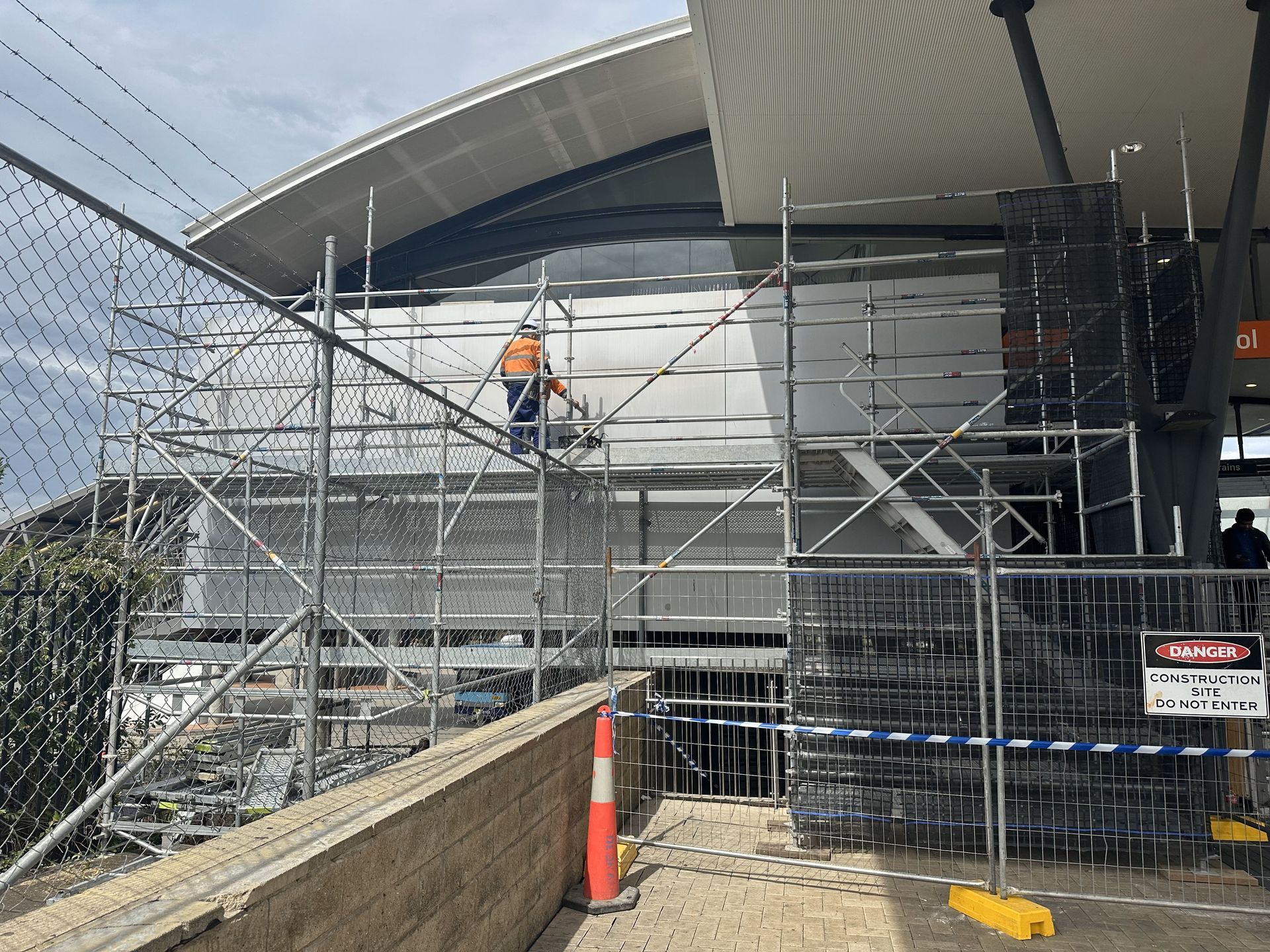 A man standing next to a set of stairs with a sign that says liverpool on it.