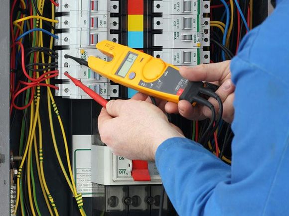 electrician testing a circuitboard