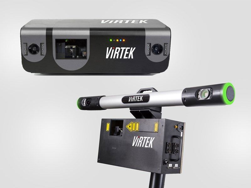 Two Virtek laser scanning systems: a handheld model and a stationary unit.