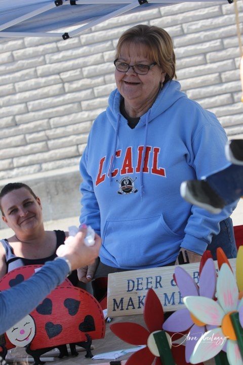 A woman wearing a blue sweatshirt that says lcahl on it