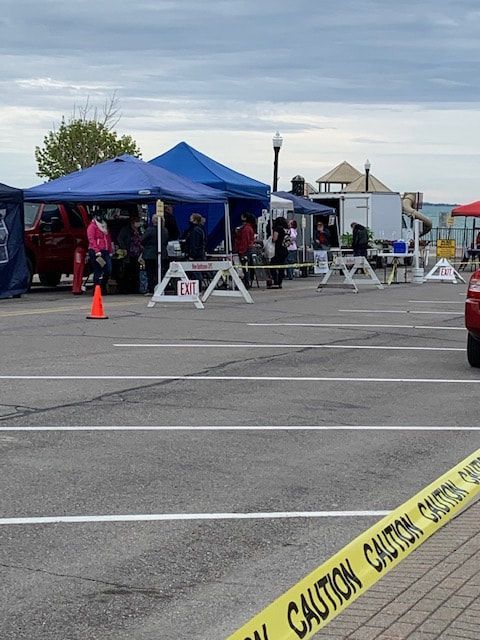 A car is parked in a parking lot next to a caution tape