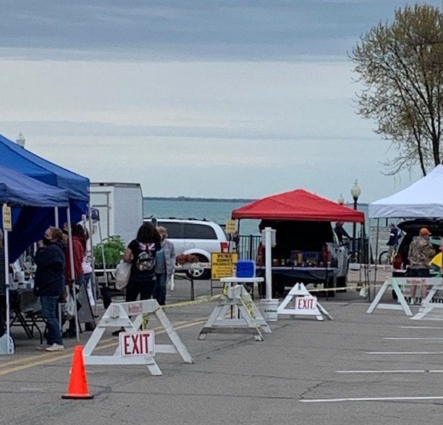A group of people standing in a parking lot with a sign that says exit
