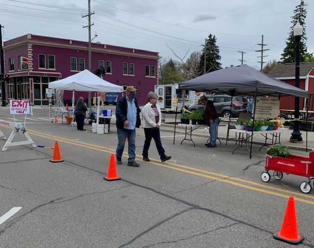 People walking down a street with a sign that says exit