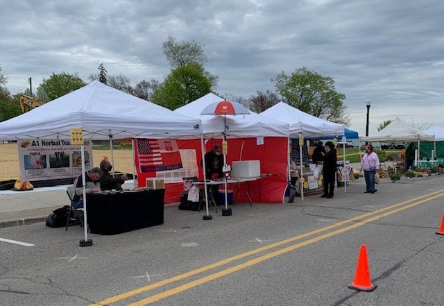 A bunch of tents are lined up on the side of the road