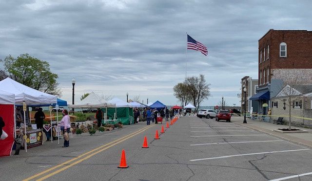 A street with a lot of tents and cones on it