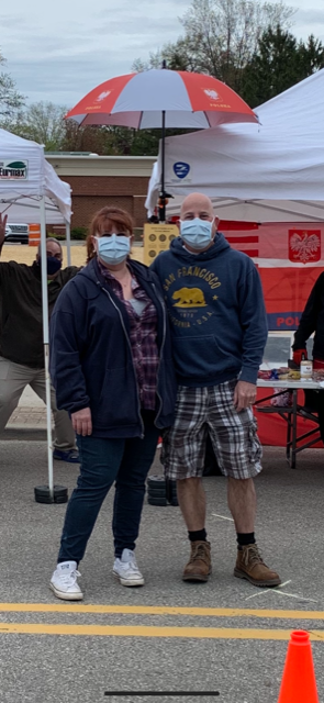 A man and a woman wearing face masks standing next to each other