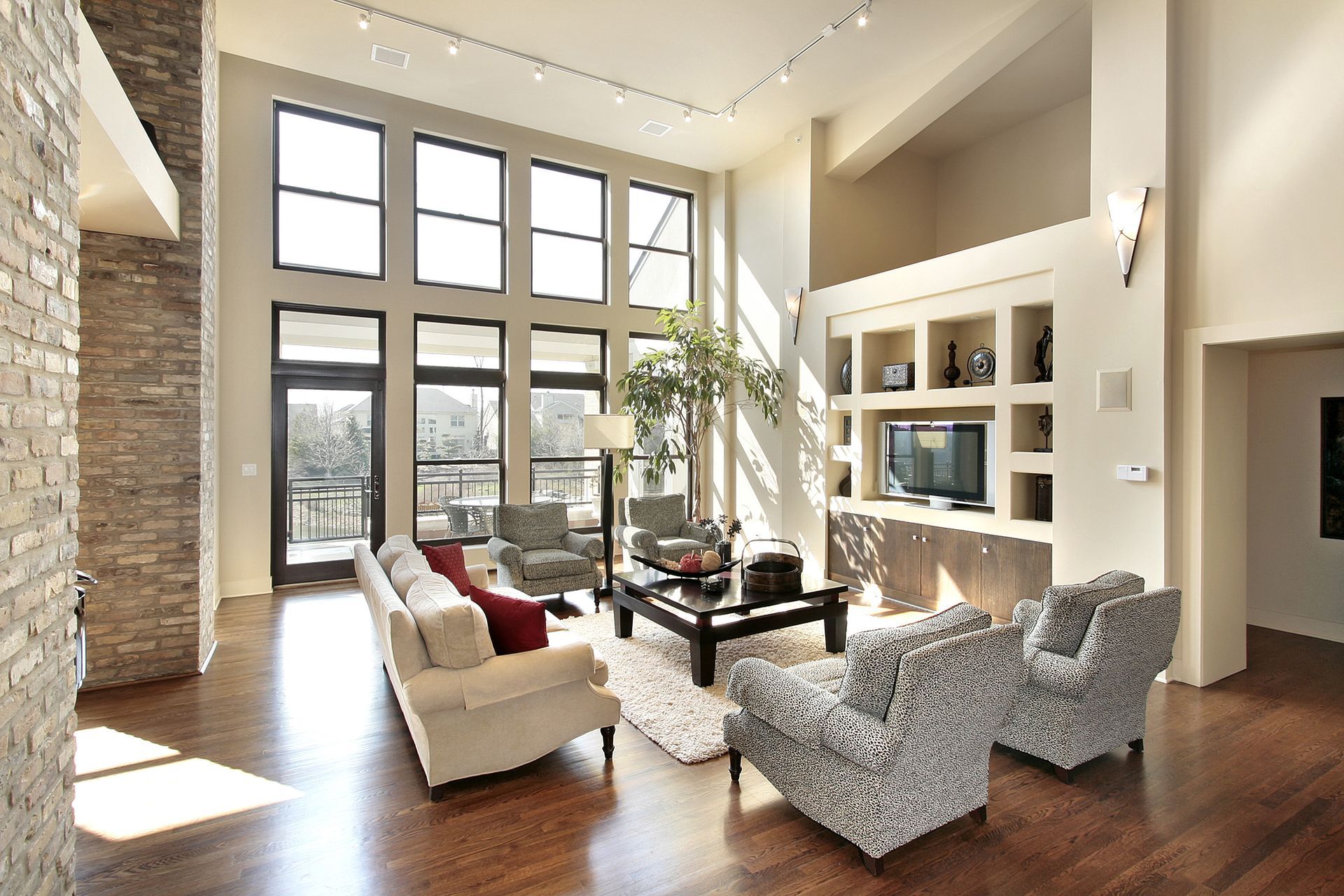 A living room with a lot of windows and furniture