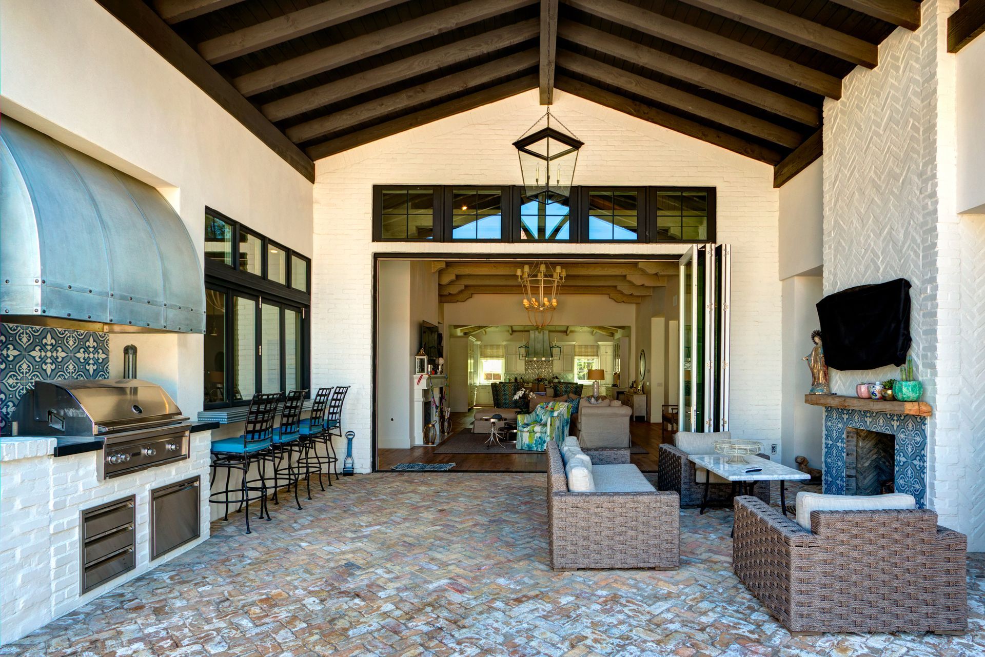 A large house with a patio area and a fireplace.
