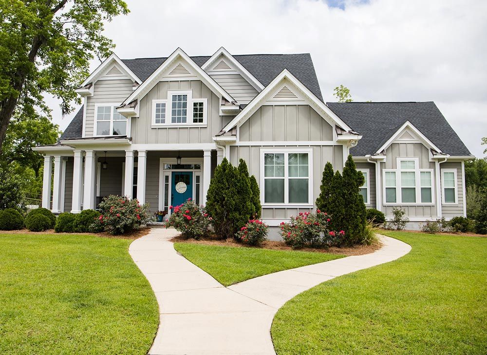 A large house with a walkway leading to it