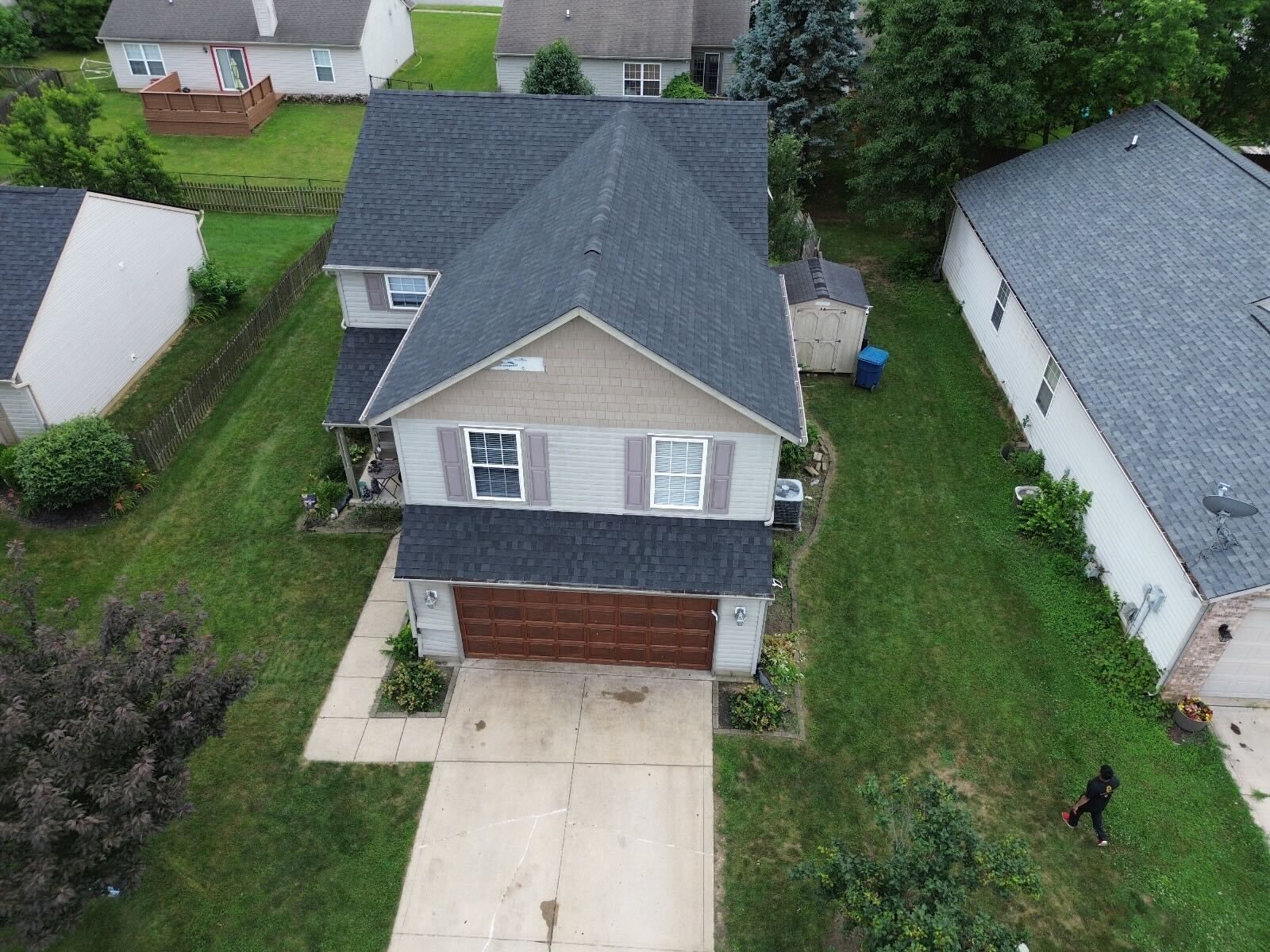 An aerial view of a house with a black roof