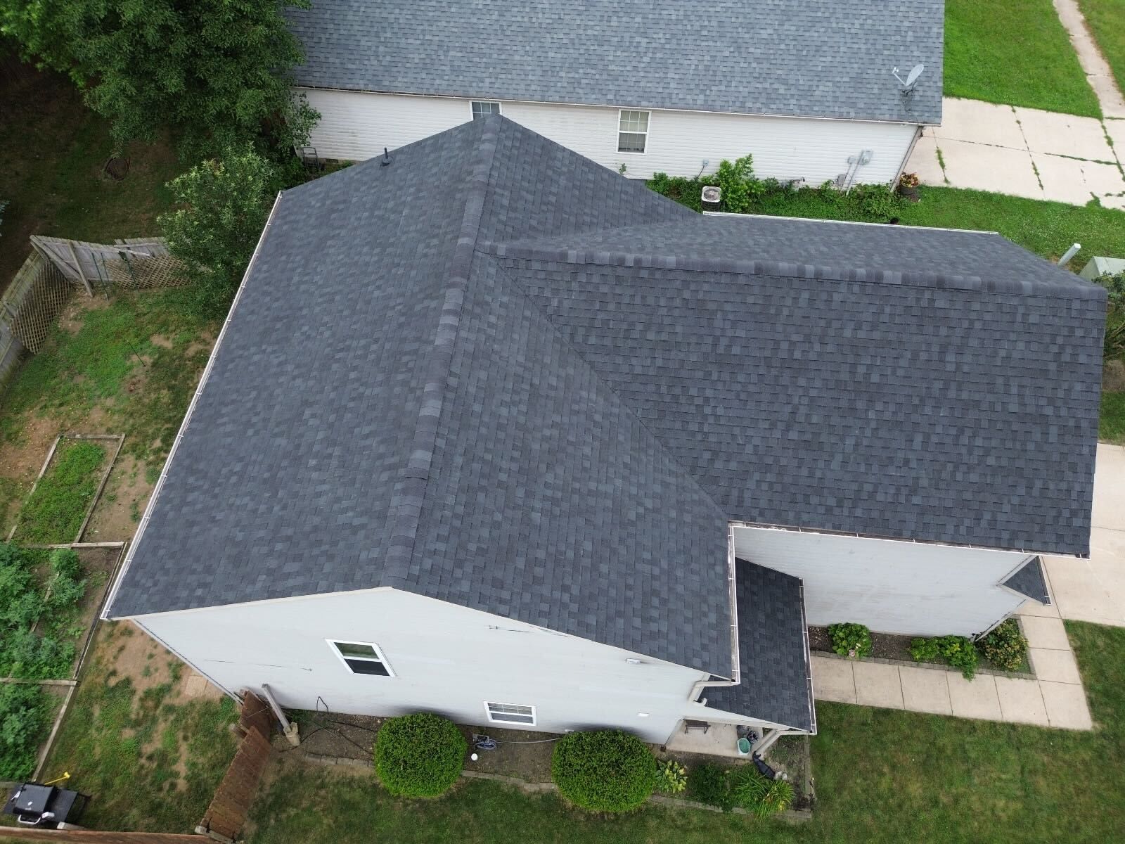 An aerial view of a house with a new roof.