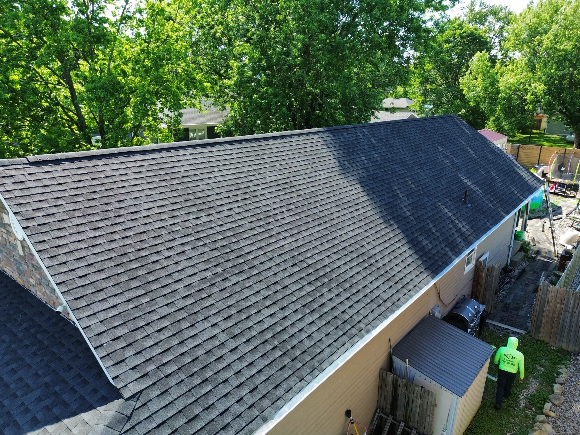 An aerial view of a house with a new roof.