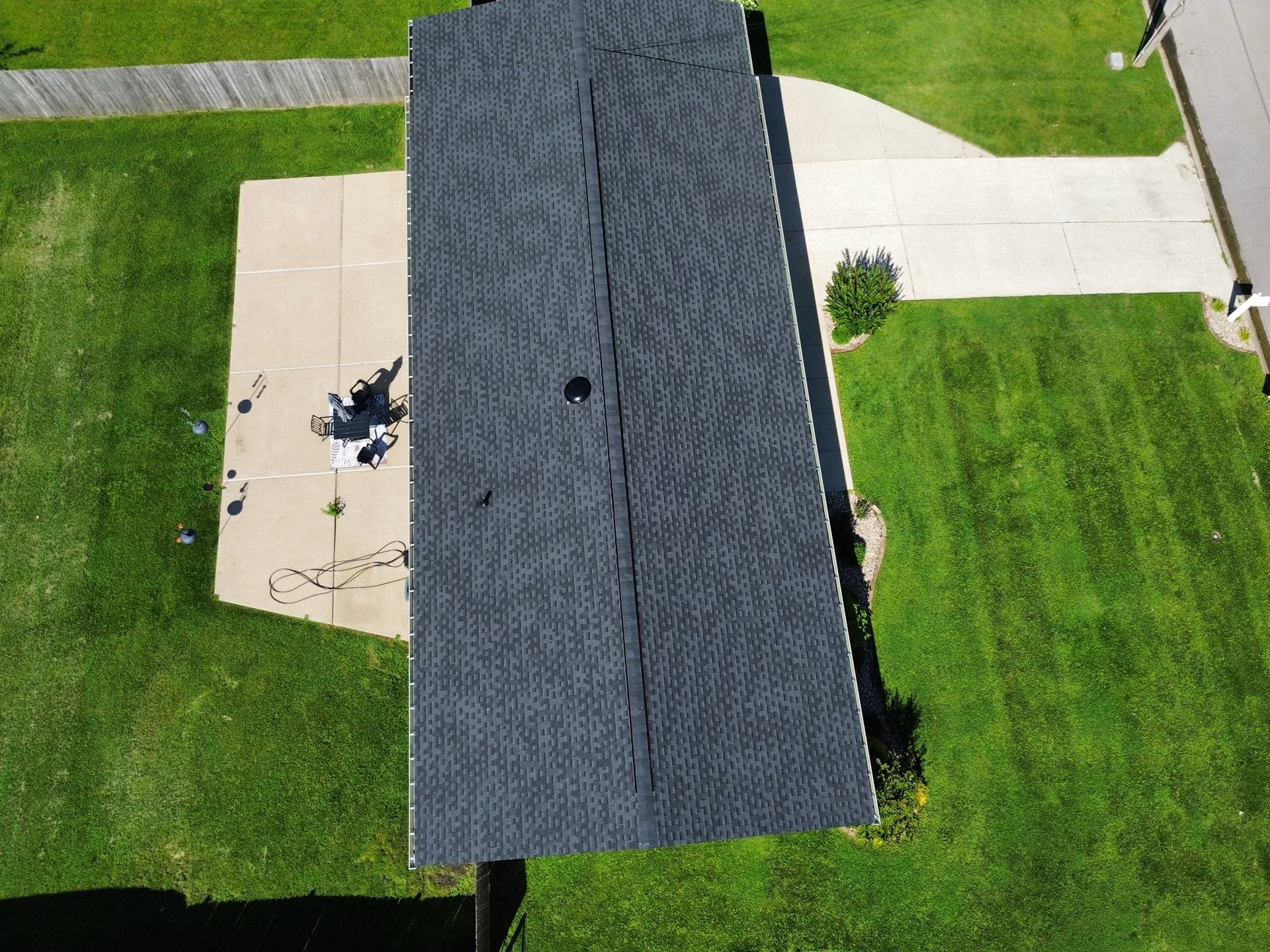 An aerial view of a house with a roof that is being repaired.