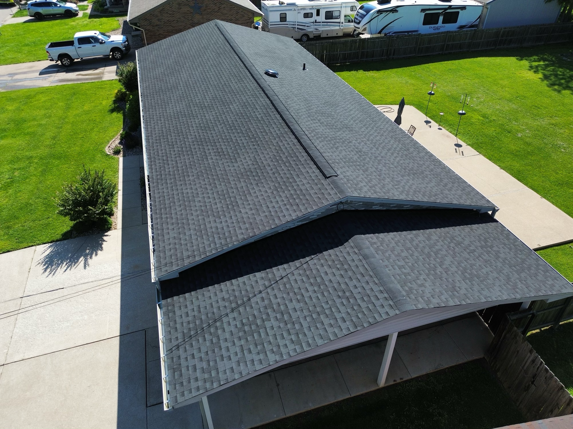 An aerial view of a house with a black roof.